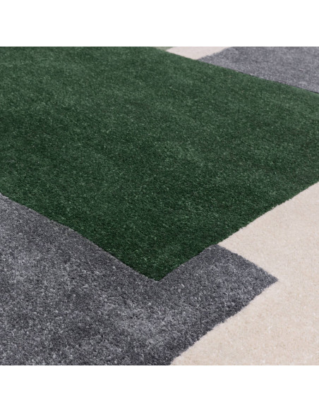 Elevate your space with the Romy 12 Papercut Green, a durable and stylish modern designer rug featuring bold geometric patterns