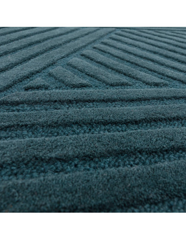 Elevate your space with the Hague Teal Rug, a minimalist rug crafted from natural wool featuring an elegant geometric design an