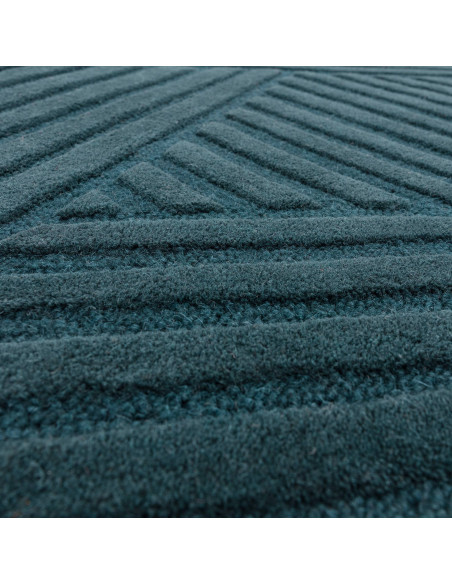 Elevate your space with the Hague Teal Rug, a minimalist rug crafted from natural wool featuring an elegant geometric design an
