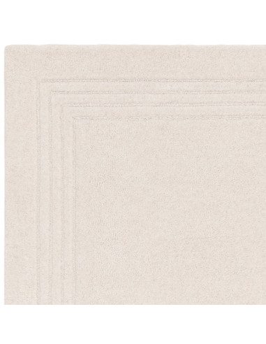 Tappeto Orlo Ivory in lana naturale, tinta unita, perfetto per ambienti minimal. Eleganza, comfort e qualità artigianale made i