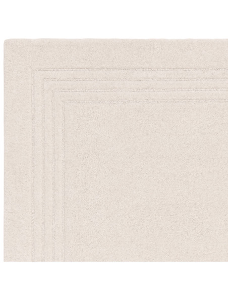 Elevate your space with the Orlo Ivory rug, a minimalist rug featuring soft wool texture and a neutral tone for timeless elegan