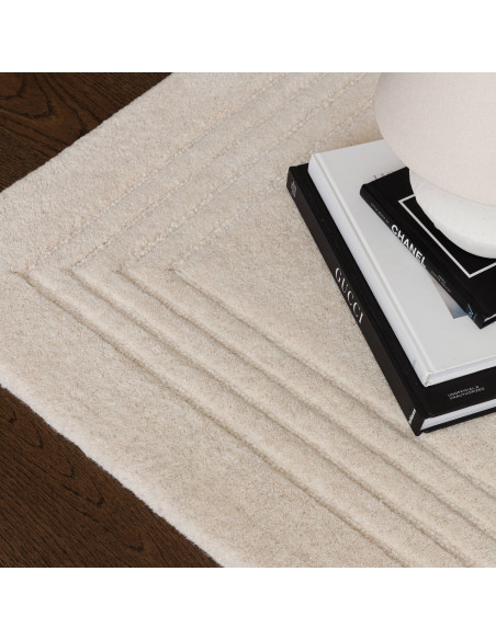 Elevate your space with the Orlo Ivory rug, a minimalist rug featuring soft wool texture and a neutral tone for timeless elegan