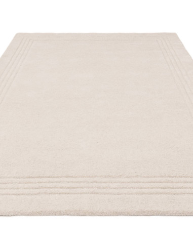 Elevate your space with the Orlo Ivory rug, a minimalist rug featuring soft wool texture and a neutral tone for timeless elegan