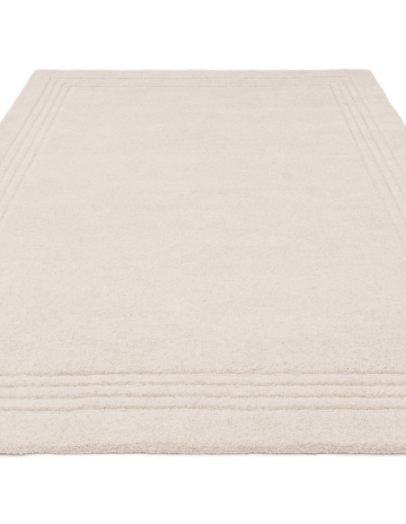Elevate your space with the Orlo Ivory rug, a minimalist rug featuring soft wool texture and a neutral tone for timeless elegan