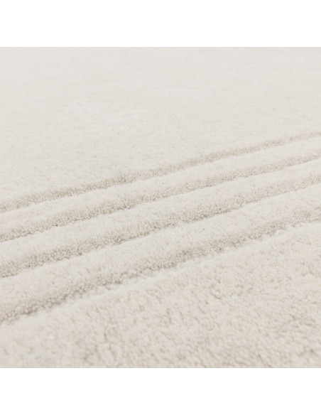 Elevate your space with the Orlo Ivory rug, a minimalist rug featuring soft wool texture and a neutral tone for timeless elegan