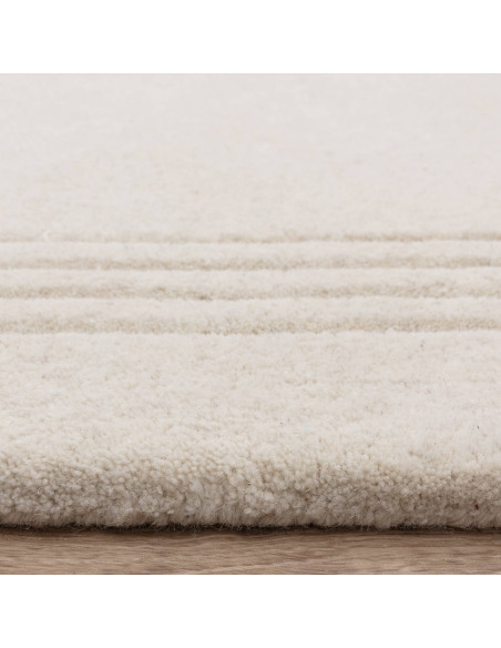 Tappeto Orlo Ivory in lana naturale, tinta unita, perfetto per ambienti minimal. Eleganza, comfort e qualità artigianale made i