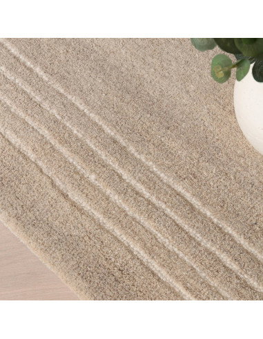 Elevate your space with the Orlo Sand rug, a durable, hand-tufted minimalist rug in a versatile neutral tone for timeless style