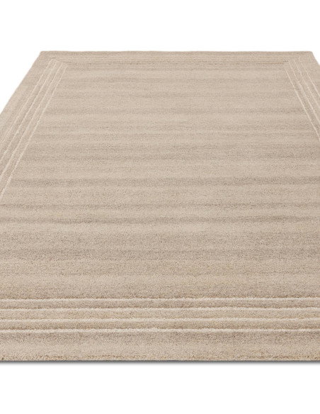 Elevate your space with the Orlo Sand rug, a durable, hand-tufted minimalist rug in a versatile neutral tone for timeless style
