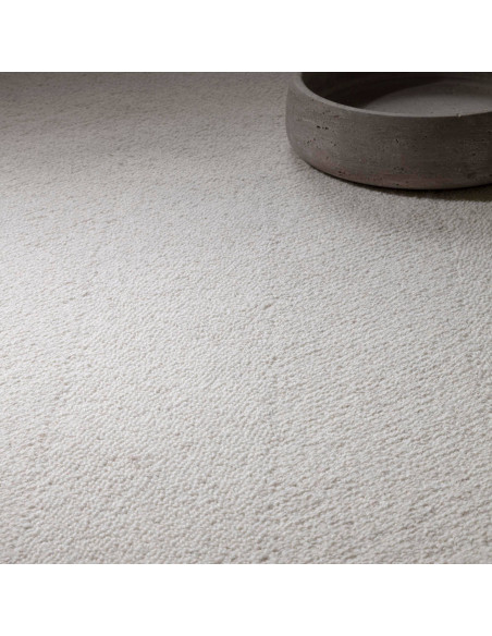 Elevate your space with the Theodore Chevron Ivory rug, a plush and durable minimalist rug featuring a subtle chevron pattern i