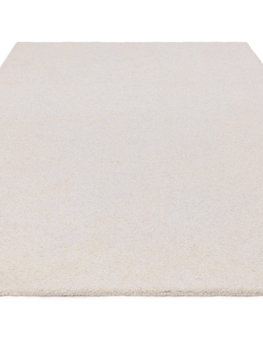 Elevate your space with the Theodore Chevron Ivory rug, a plush and durable minimalist rug featuring a subtle chevron pattern i
