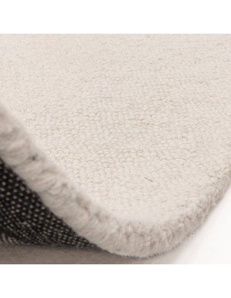 Elevate your space with the Theodore Chevron Ivory rug, a plush and durable minimalist rug featuring a subtle chevron pattern i