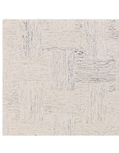 Elevate your space with the Theodore Chevron Sand rug—a hand-tufted, natural wool blend perfect for minimalist rugs lovers seek