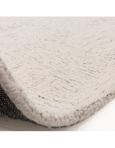 Elevate your space with the Theodore Chevron Sand rug—a hand-tufted, natural wool blend perfect for minimalist rugs lovers seek
