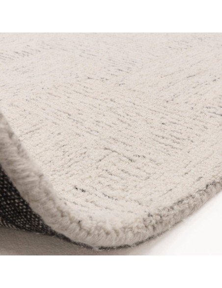 Elevate your space with the Theodore Chevron Sand rug—a hand-tufted, natural wool blend perfect for minimalist rugs lovers seek
