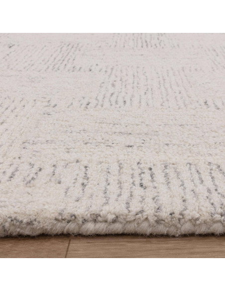 Elevate your space with the Theodore Chevron Sand rug—a hand-tufted, natural wool blend perfect for minimalist rugs lovers seek
