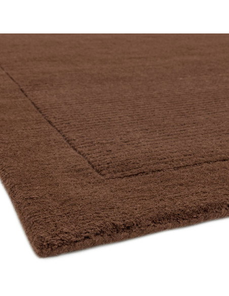 Elevate your space with the York Chocolate rug, a minimalist rug featuring a warm chocolate tone and elegant geometric border f