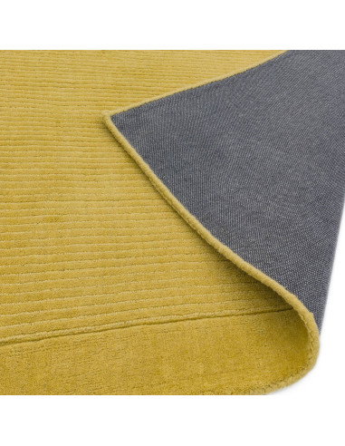 Brighten your space with the York Yellow rug, a hand-woven minimalist rug in natural wool featuring an elegant geometric design