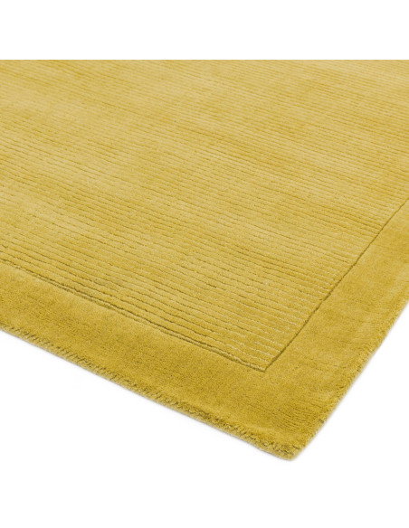 Brighten your space with the York Yellow rug, a hand-woven minimalist rug in natural wool featuring an elegant geometric design