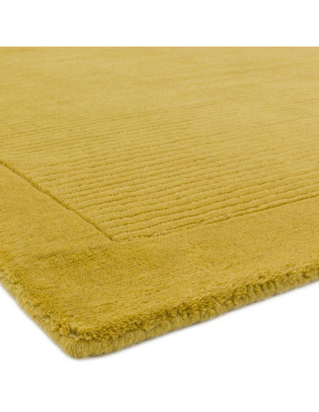 Brighten your space with the York Yellow rug, a hand-woven minimalist rug in natural wool featuring an elegant geometric design