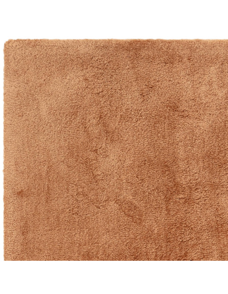 Experience luxurious softness with the Opulence Terra shaggy rug, featuring a warm terra tone and plush texture perfect for any