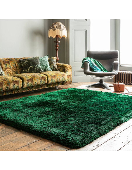 Add luxurious softness and vibrant emerald color to your space with this durable, hand-made plush shaggy rug—perfect for any mo