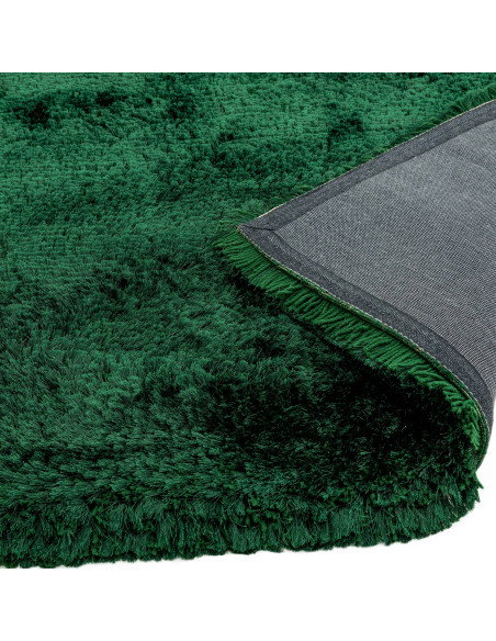 Add luxurious softness and vibrant emerald color to your space with this durable, hand-made plush shaggy rug—perfect for any mo