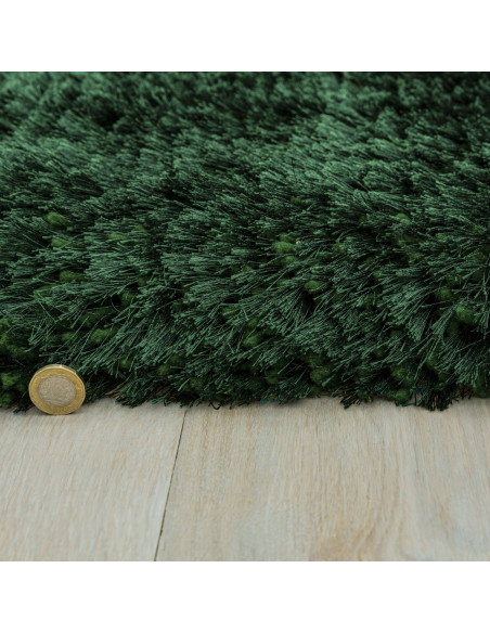 Add luxurious softness and vibrant emerald color to your space with this durable, hand-made plush shaggy rug—perfect for any mo