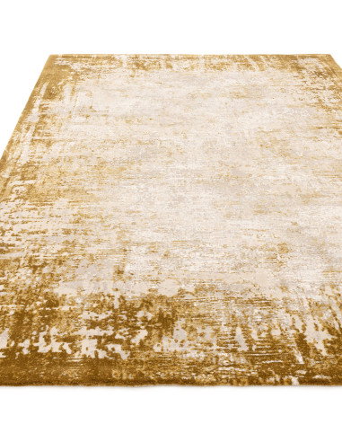 Elevate your space with the Kuza Border Gold rug, a durable modern luxury rug featuring a lustrous silk look and a rich golden