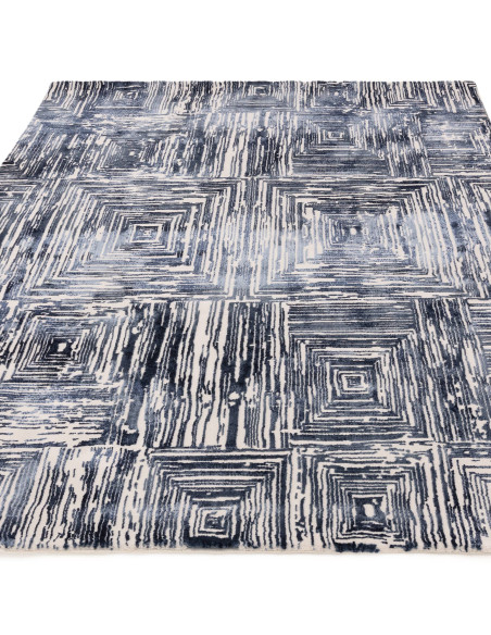 Elevate your space with the Kuza Portrait Navy modern luxury rug, featuring a lustrous geometric design and soft, durable synth